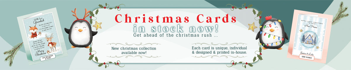 Promotional banner for Christmas cards showing three sample card designs, penguin illustrations, and text reading 'Christmas Cards in stock now!' on a teal background.