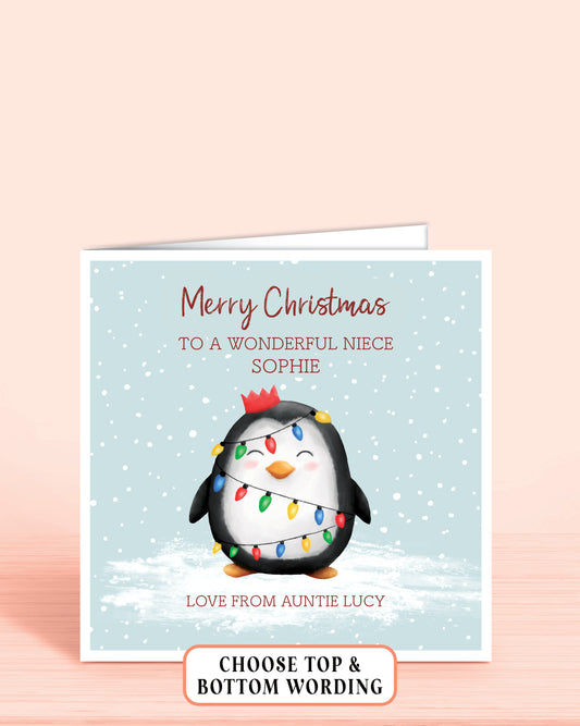 Personalised Christmas card with a cheeky penguin holding christmas lights on a light blue snowy background, 6x6 inches with envelope