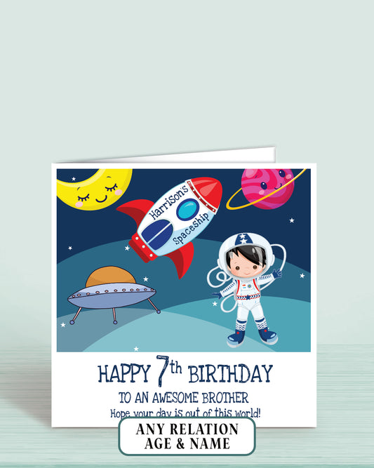 Children's birthday card with space theme, astronaut, and rocket ship on a blue background.