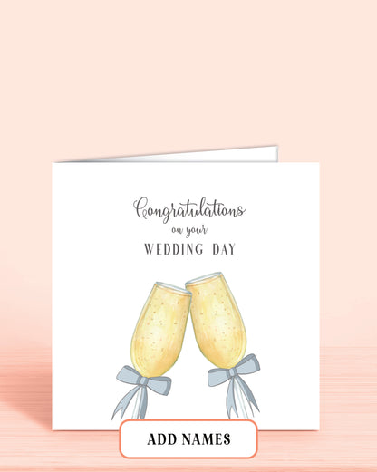 Wedding Day card with Printed Champagne Glasses with Blue Bows. Words on front: Congratulations on your Wedding Day.